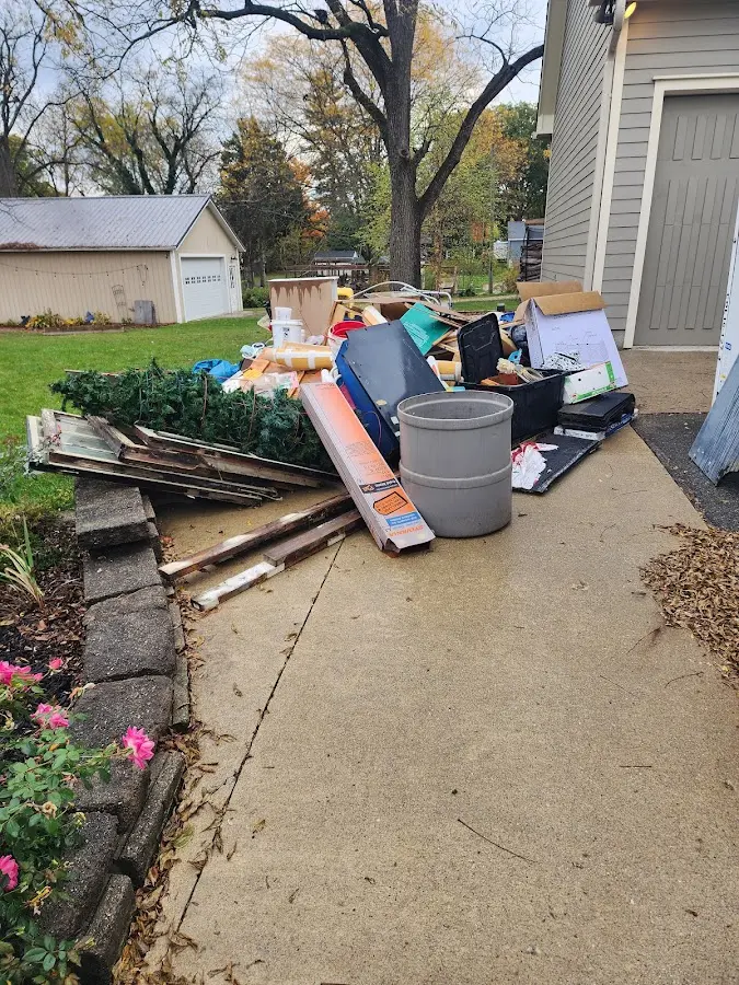 Dumpster being loaded with debris for 12 Yard Dumpster Rental in Idaho Falls